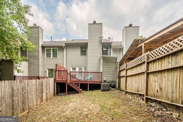 rear view of house featuring central air condition unit and a wooden deck