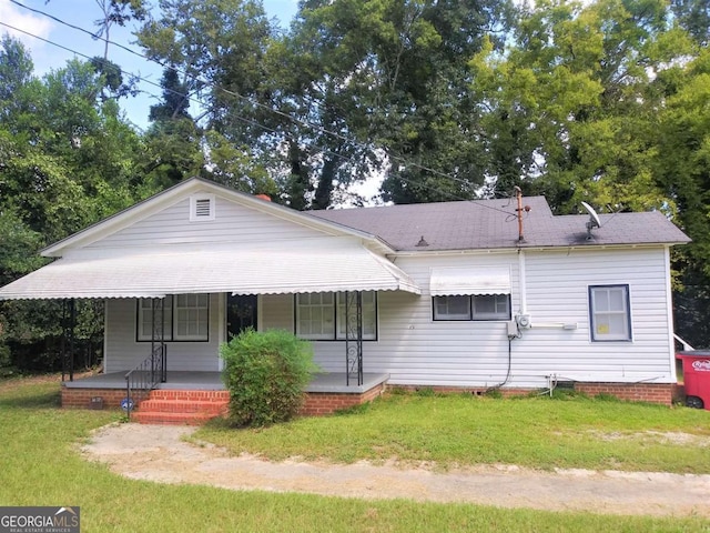 view of front of home with a porch and a front yard