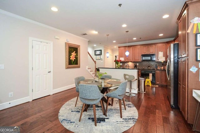 dining room featuring ornamental molding and dark wood-type flooring