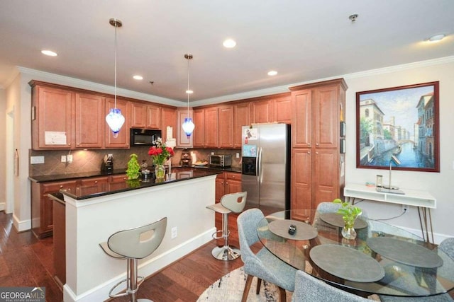 kitchen featuring stainless steel refrigerator with ice dispenser, hanging light fixtures, dark hardwood / wood-style floors, decorative backsplash, and ornamental molding