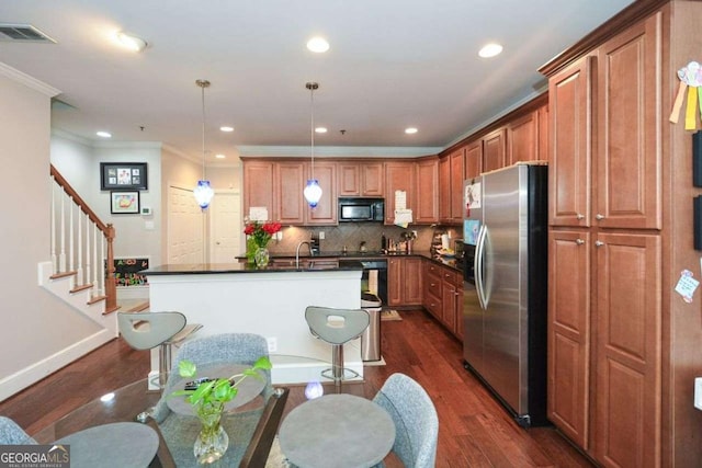 kitchen featuring pendant lighting, backsplash, dark wood-type flooring, ornamental molding, and stainless steel fridge with ice dispenser