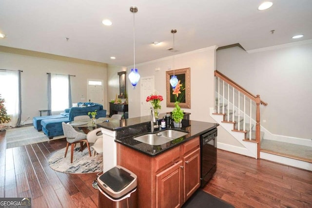 kitchen with sink, black dishwasher, dark hardwood / wood-style flooring, dark stone countertops, and an island with sink