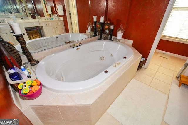 bathroom featuring vanity, tile patterned floors, and tiled tub