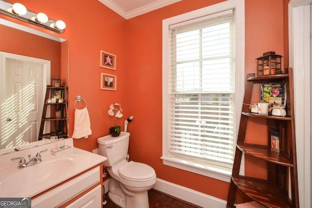 bathroom with crown molding, hardwood / wood-style floors, vanity, and toilet