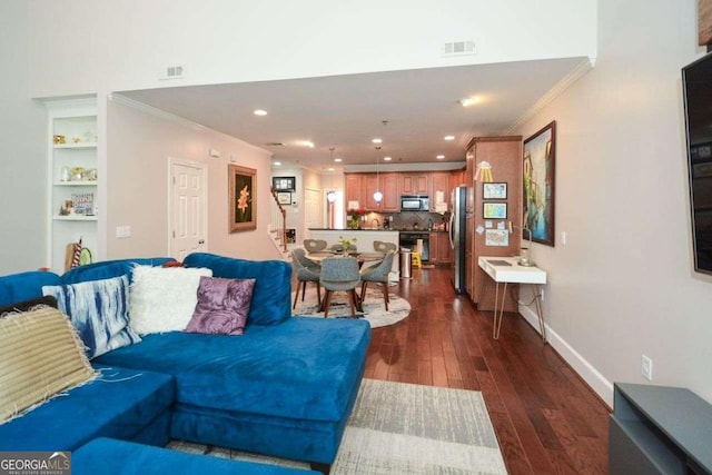 living room featuring dark hardwood / wood-style flooring and crown molding