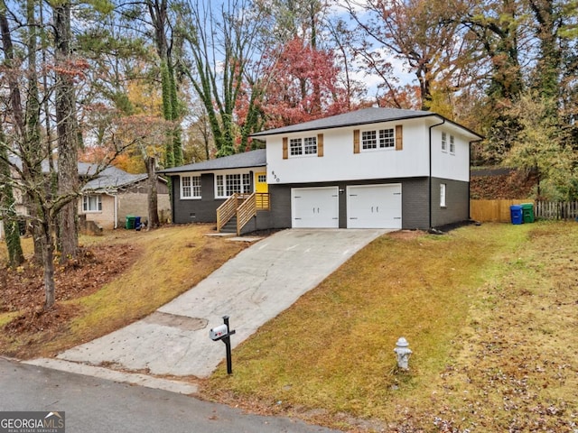 split level home featuring a front yard and a garage