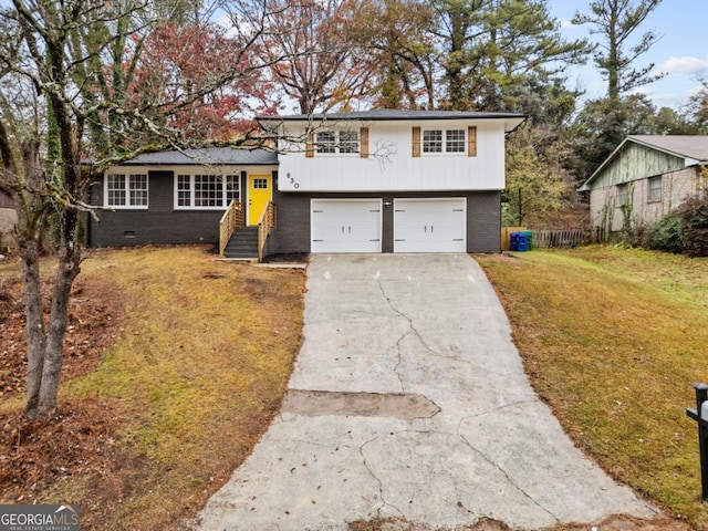 tri-level home featuring a front yard and a garage