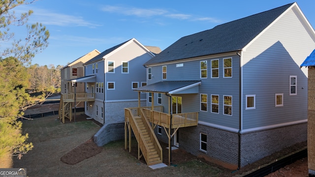 back of house featuring a deck