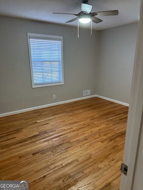 unfurnished room with ceiling fan and light hardwood / wood-style flooring