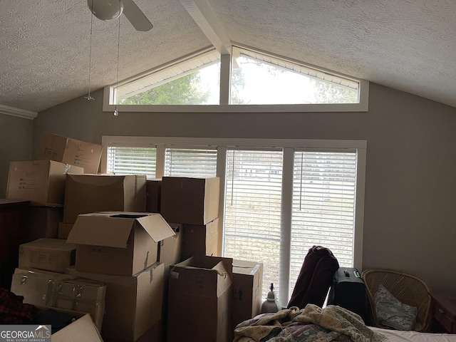 interior space with lofted ceiling with beams and a textured ceiling