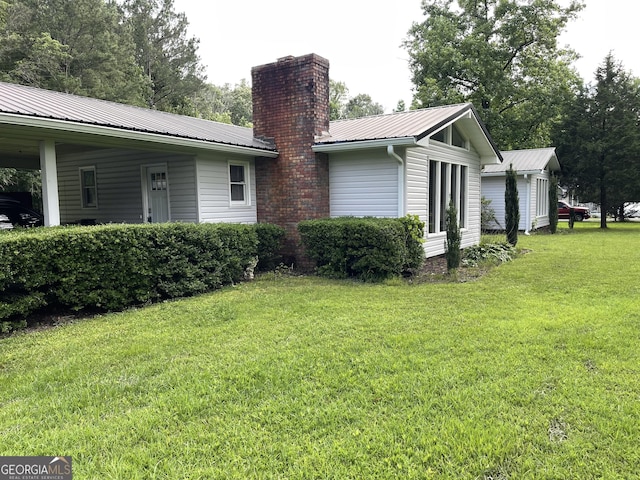 1088 New Rosedale Rd NE, Armuchee, GA 30105 - view of property exterior featuring a chimney, a yard, and metal roof
