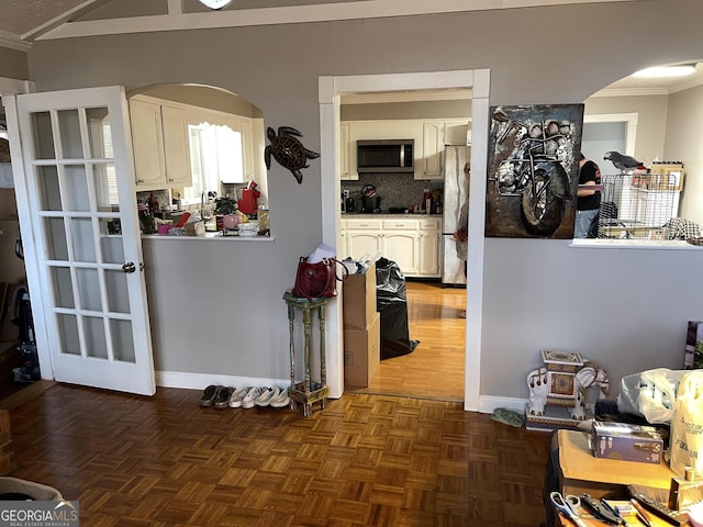 interior space featuring dark parquet floors and crown molding