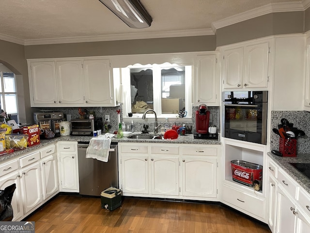 kitchen with white cabinetry, stainless steel appliances, dark hardwood / wood-style floors, decorative backsplash, and ornamental molding