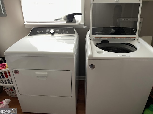 laundry area with washer and dryer and wood-type flooring