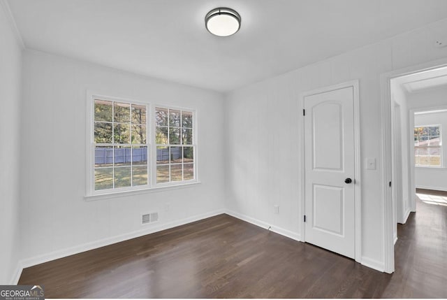 spare room with dark hardwood / wood-style floors