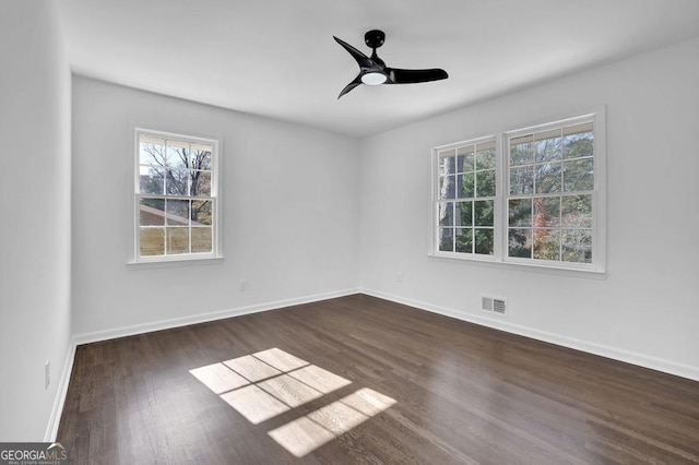 empty room with ceiling fan and dark wood-type flooring