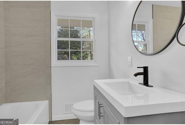 bathroom featuring vanity and toilet