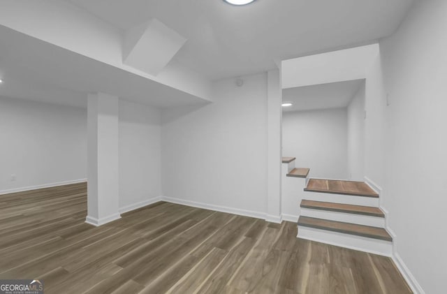 additional living space featuring dark wood-type flooring