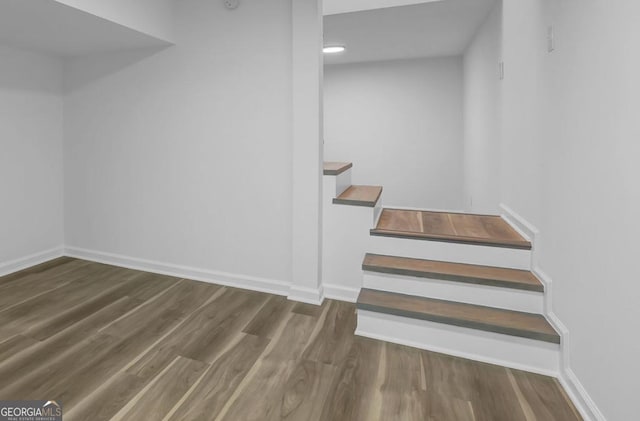 stairs with hardwood / wood-style floors