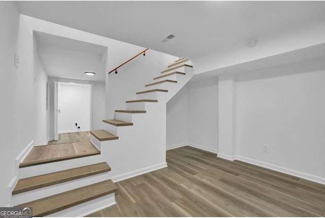 staircase featuring hardwood / wood-style floors