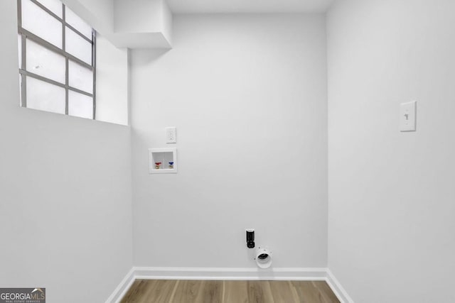 laundry room featuring electric dryer hookup, hardwood / wood-style floors, and washer hookup