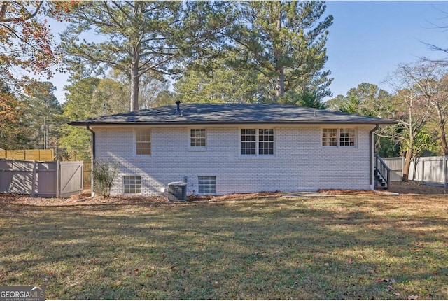 rear view of property featuring a yard