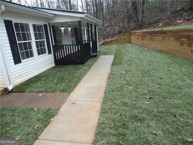 view of yard featuring covered porch