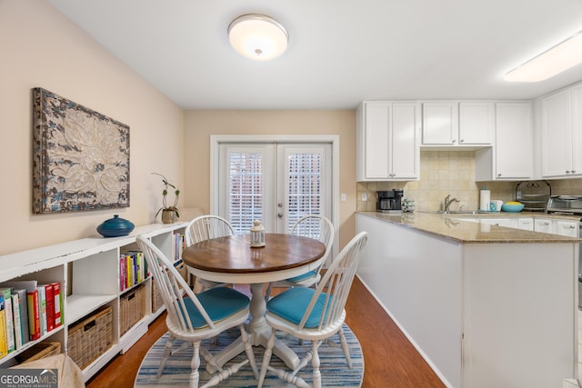 dining area with french doors and dark wood-type flooring