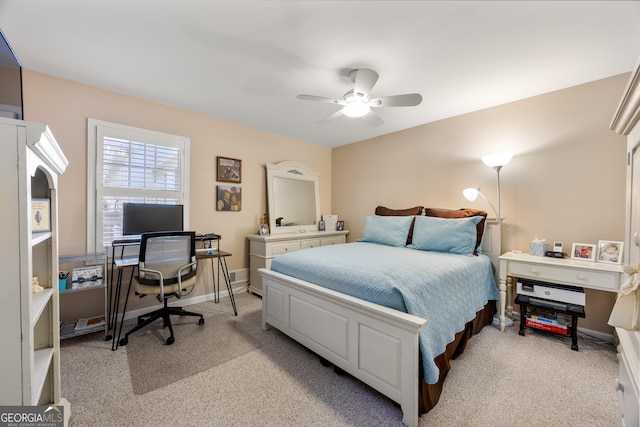 bedroom with ceiling fan and light carpet