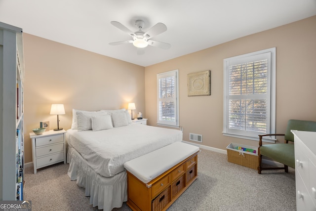 bedroom with ceiling fan and light carpet