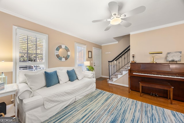 living room with ceiling fan, wood-type flooring, and ornamental molding