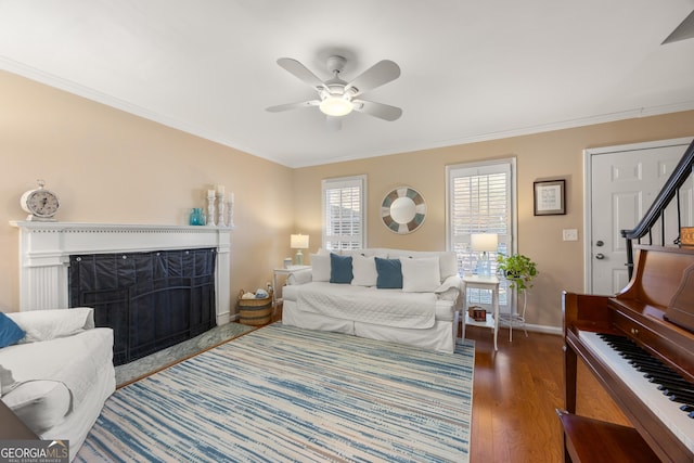 bedroom featuring ceiling fan, crown molding, and dark wood-type flooring