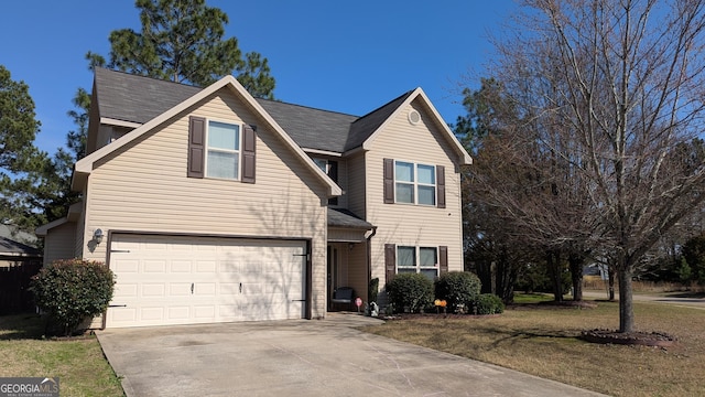 front of property featuring a front yard and a garage