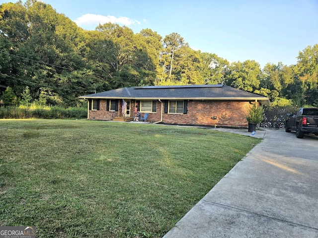 ranch-style home with a front lawn