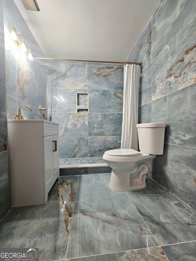 bathroom featuring toilet, tile walls, and walk in shower