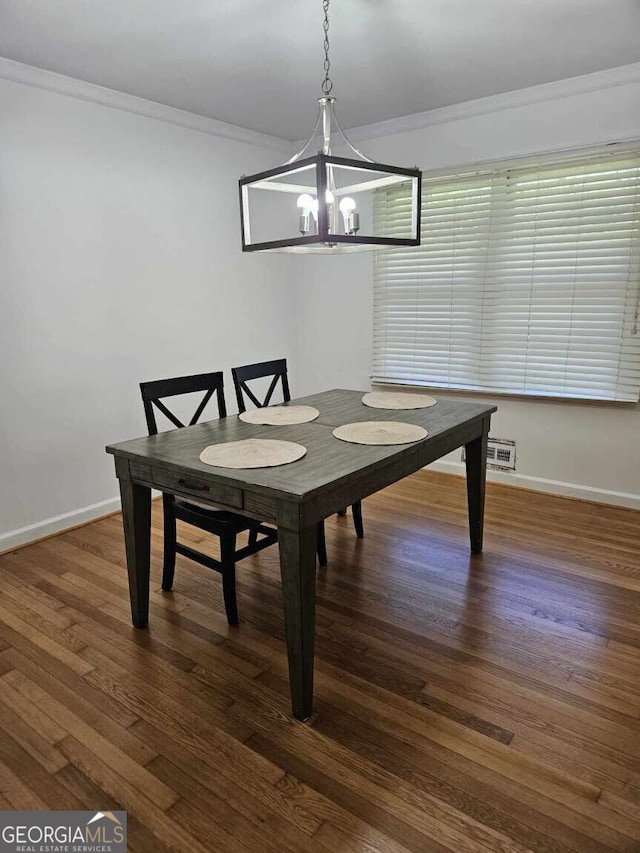 dining space featuring dark hardwood / wood-style flooring and ornamental molding