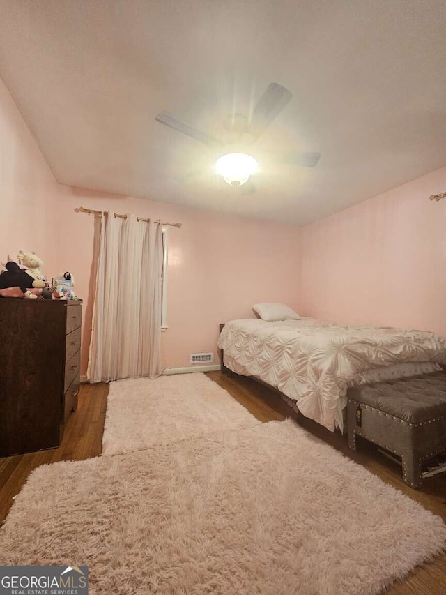 bedroom featuring ceiling fan and dark hardwood / wood-style floors