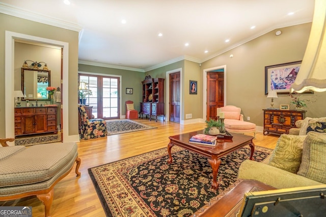 living room with light hardwood / wood-style flooring, french doors, and ornamental molding