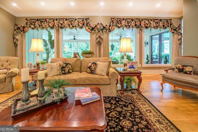 living room with hardwood / wood-style floors, plenty of natural light, ceiling fan, and crown molding