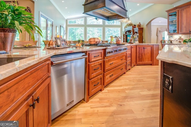 kitchen with premium range hood, light hardwood / wood-style flooring, ornamental molding, light stone counters, and stainless steel appliances