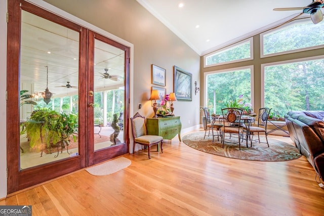 interior space featuring hardwood / wood-style floors, ceiling fan, lofted ceiling, and ornamental molding