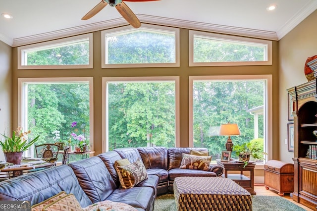 living room with wood-type flooring, crown molding, a wealth of natural light, and lofted ceiling