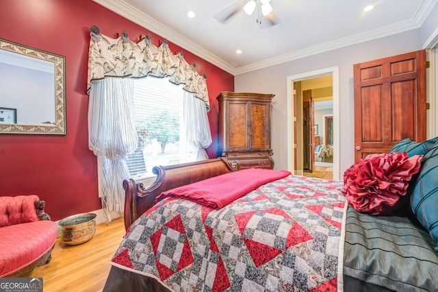 bedroom featuring ceiling fan, light hardwood / wood-style floors, ensuite bathroom, and crown molding