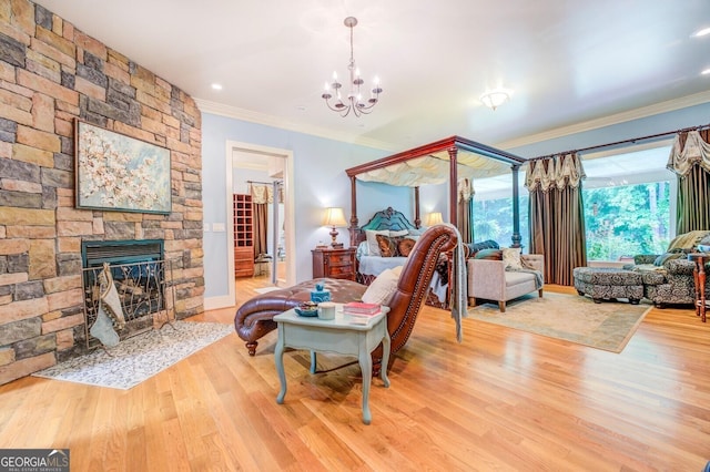 living room with hardwood / wood-style floors, a stone fireplace, and crown molding