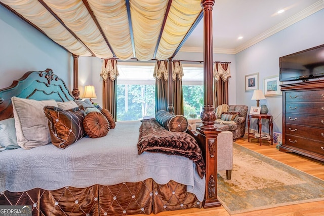 bedroom featuring light wood-type flooring and crown molding