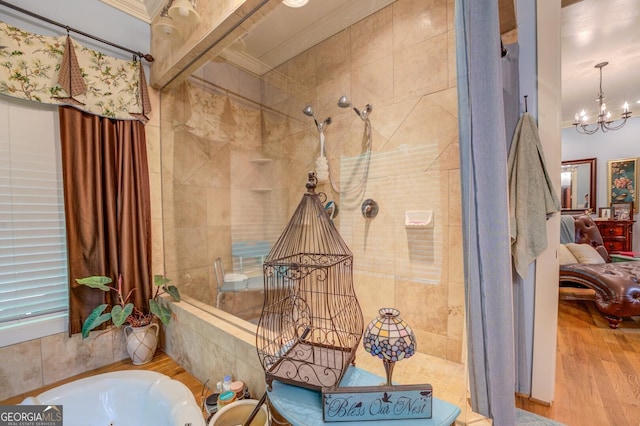 bathroom with crown molding, an inviting chandelier, shower with separate bathtub, and hardwood / wood-style flooring