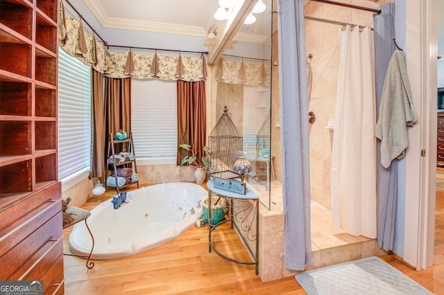 bathroom with crown molding, hardwood / wood-style floors, and independent shower and bath