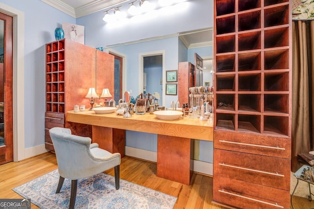 bathroom with crown molding, vanity, and wood-type flooring