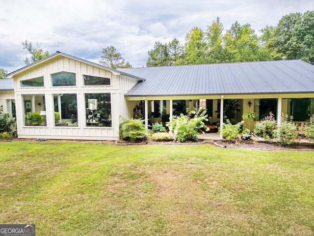 rear view of property with a lawn