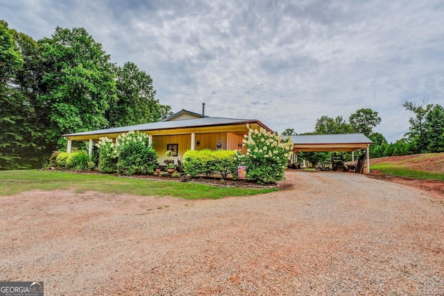 view of front of house featuring a carport and covered porch